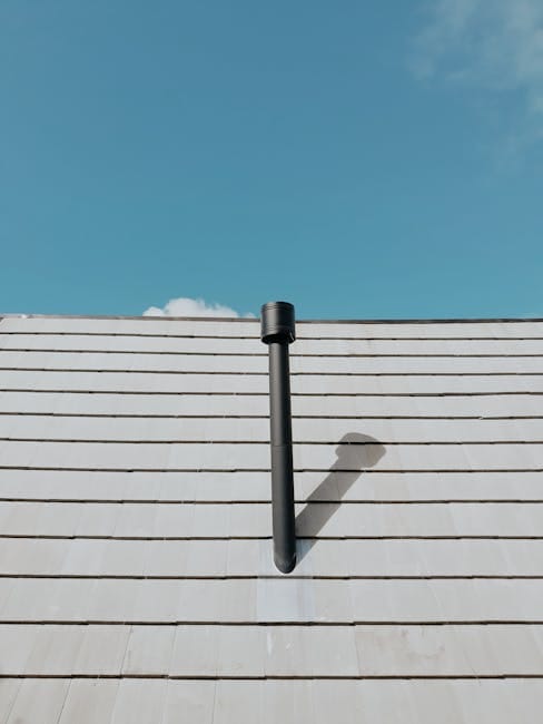 Plumber inspecting drain vent pipe on roof of a Punta Gorda slab-on-grade home