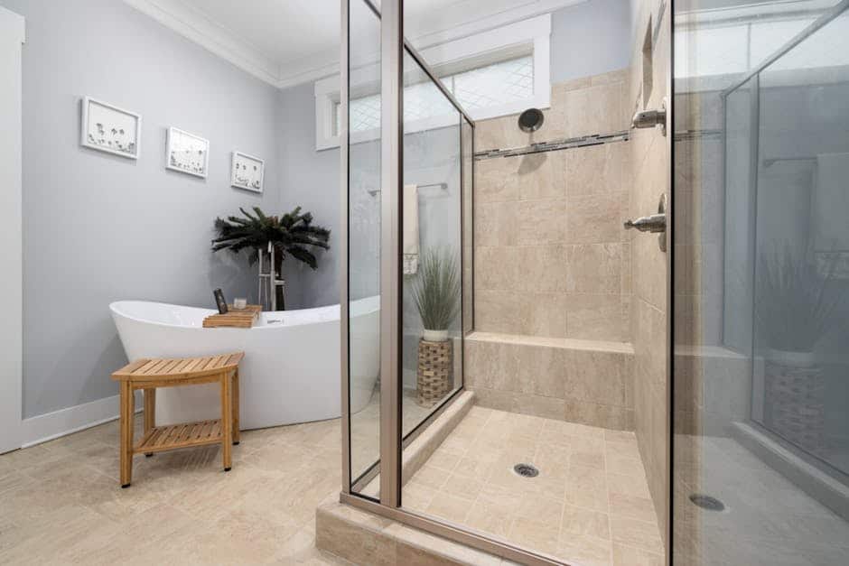 Walk-in shower conversion with tile surround and frameless glass door in a Lehigh Acres home