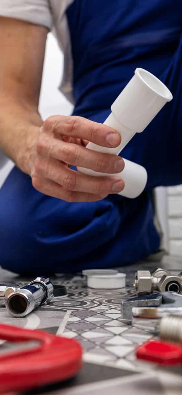 Plumbers,Working,On,Pipes,Under,Sink Plumbers working on pipes under sink