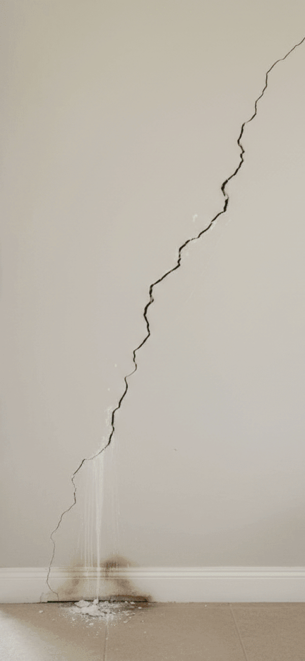 Foundation wall crack from slab leak water damage