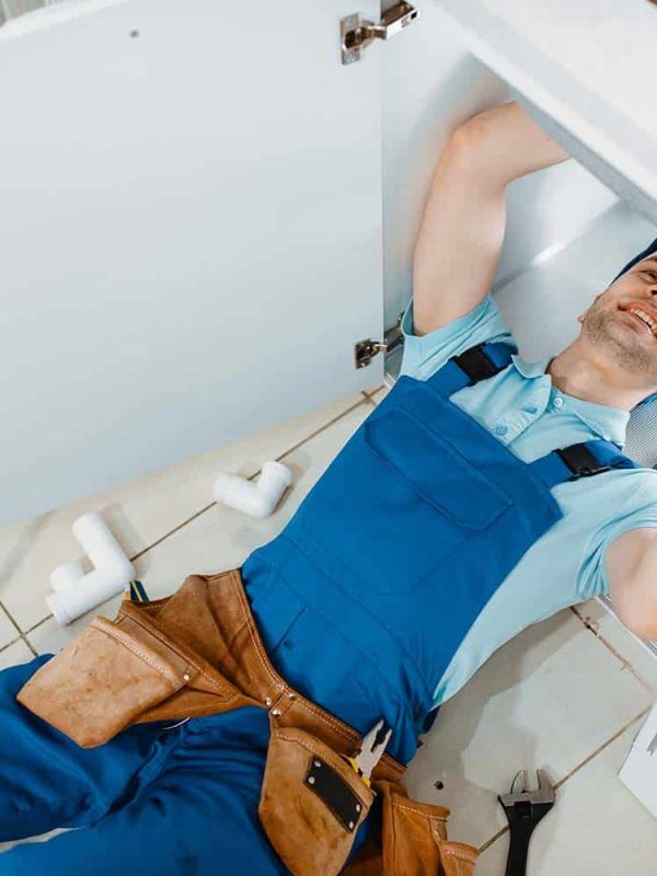 Plumber In Uniform Installing Drain Pipe Top View Resize Jpg Fort Myers FL | Waterway Plumbing