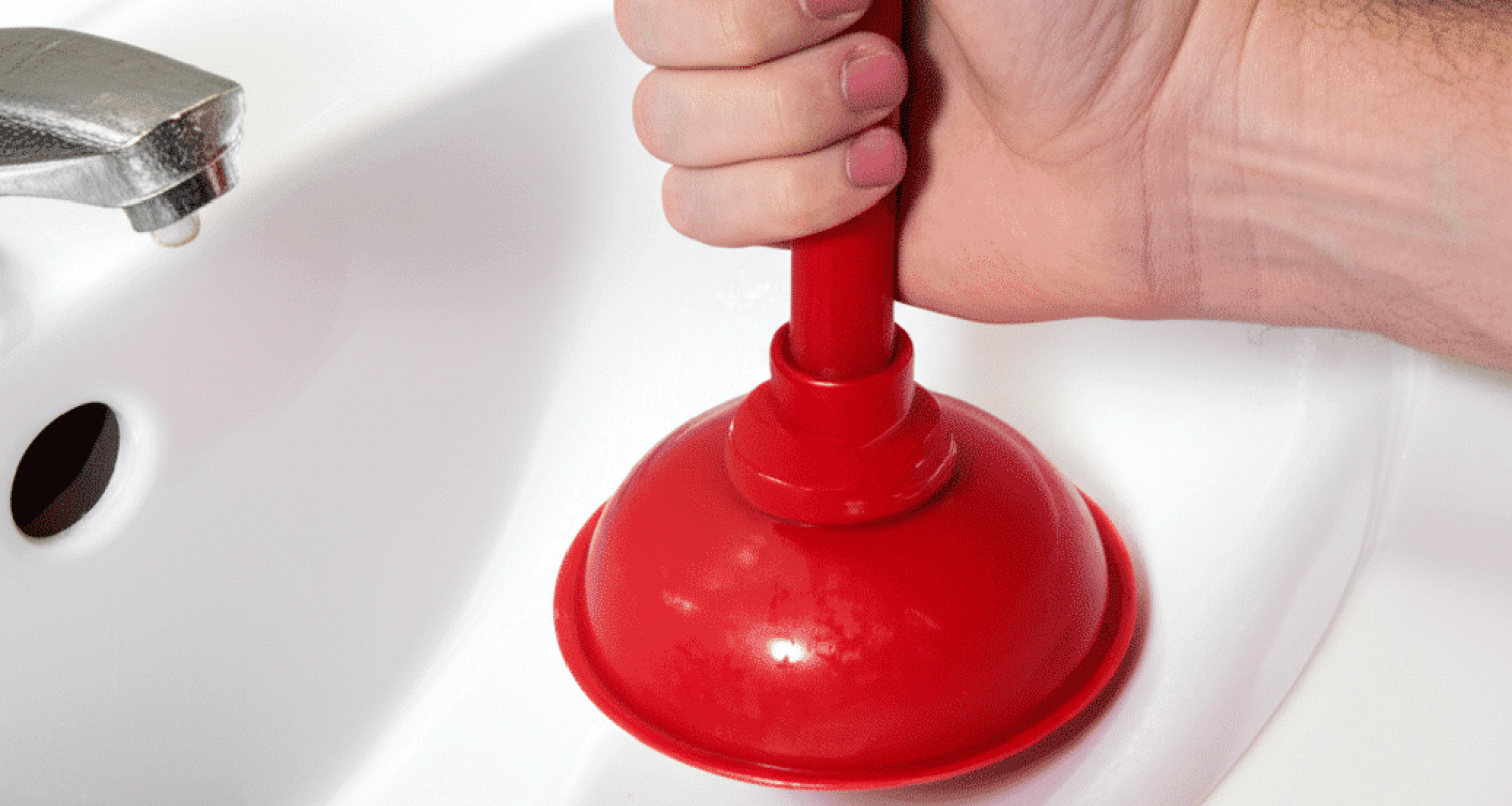 Using a cup plunger to unclog a bathroom sink drain with proper technique