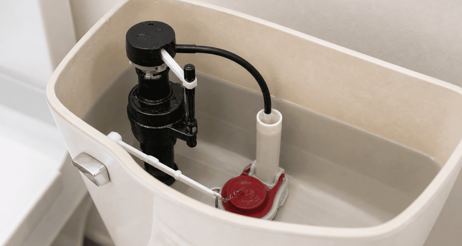 Toilet tank interior showing flapper fill valve and overflow tube components